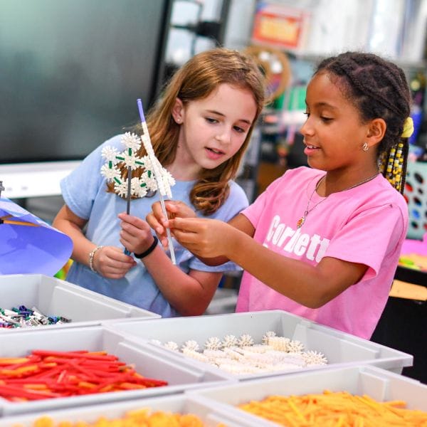 Two girls working with crafts