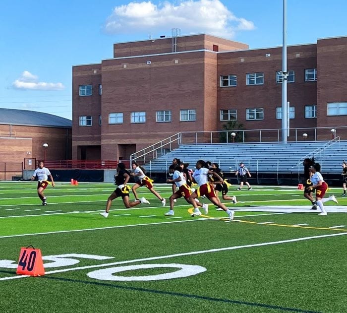 Ferrell Girls Preparatory Academy athletes running on field