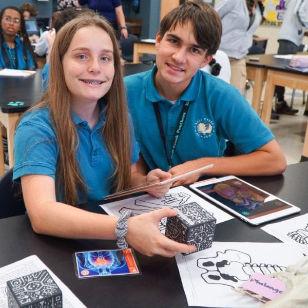 Students seated side by side at desk