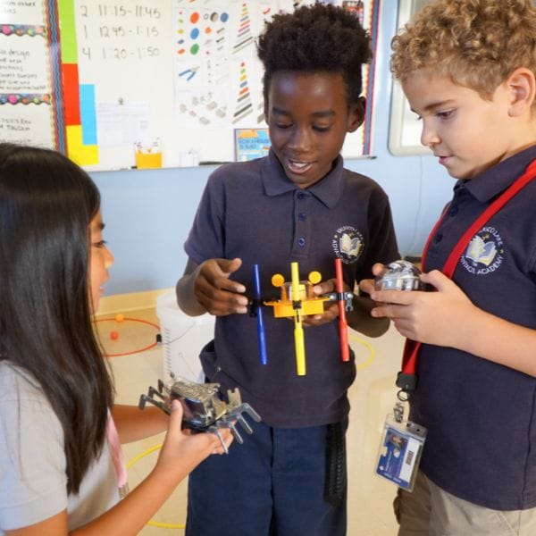 Three students comparing robotics