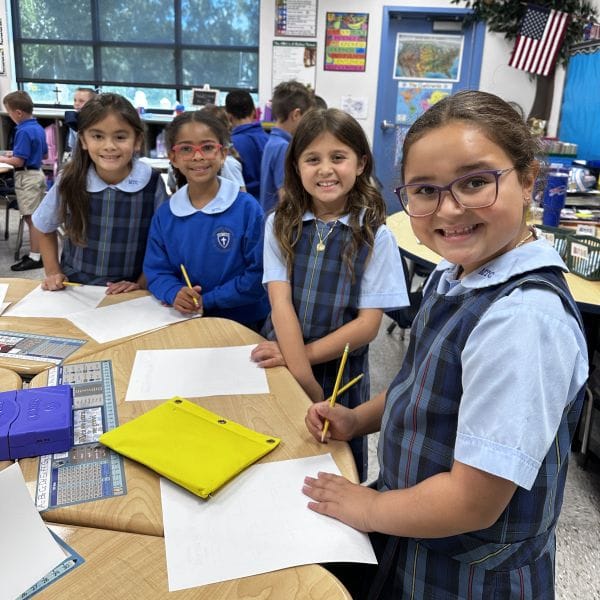 Female students lined up behind their desk