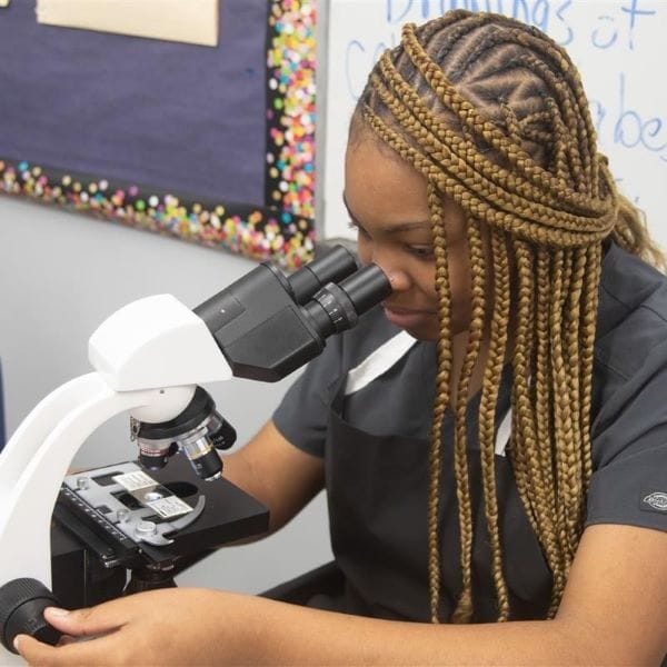 Medical Academy at DW Waters student looking in microscope