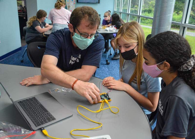 Teacher helps wire microcontrollers