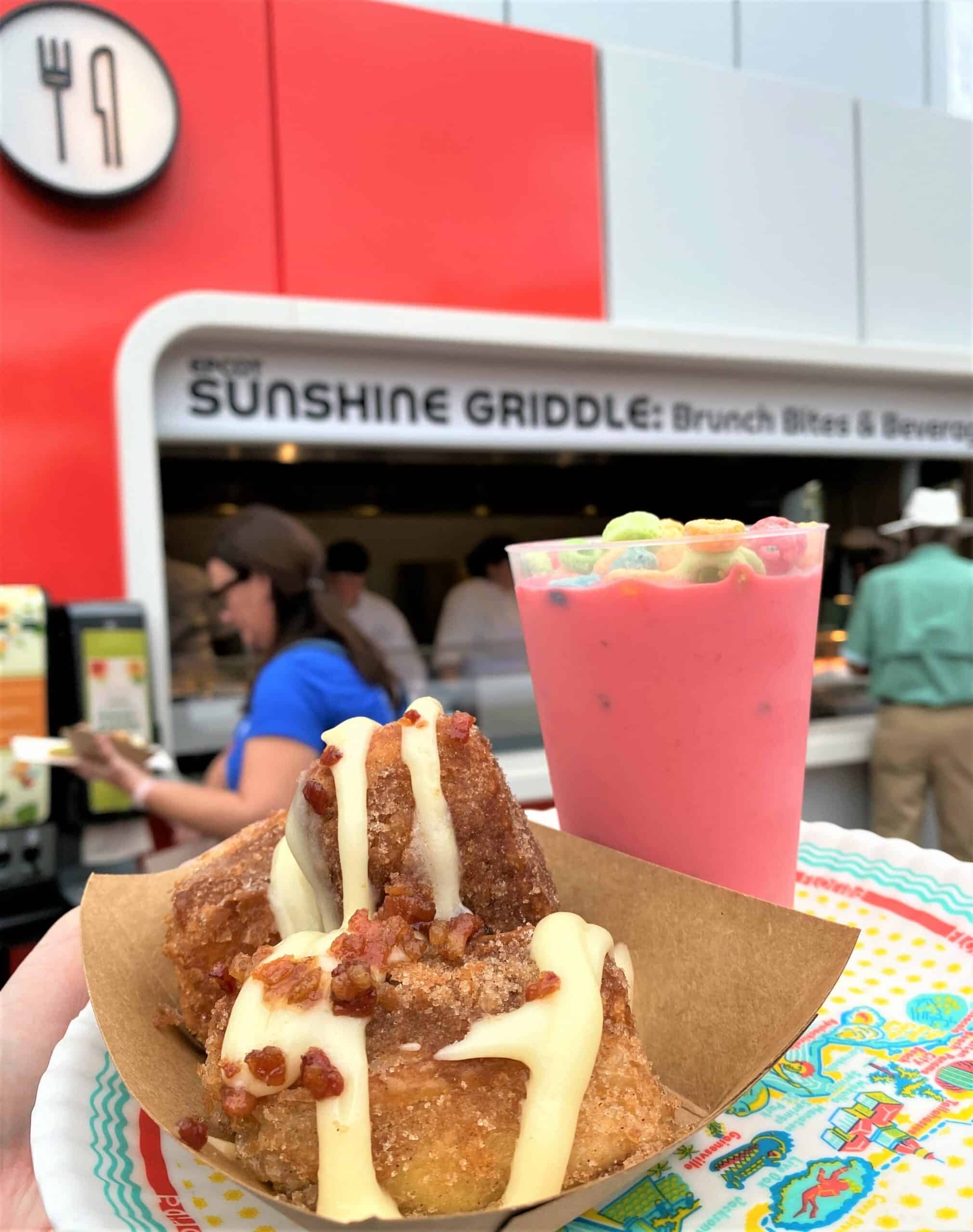 Cinnamon Bites and Fruit Loops shake held in front of Sunshine Griddle booth at Epcot Flower and Garden 2022