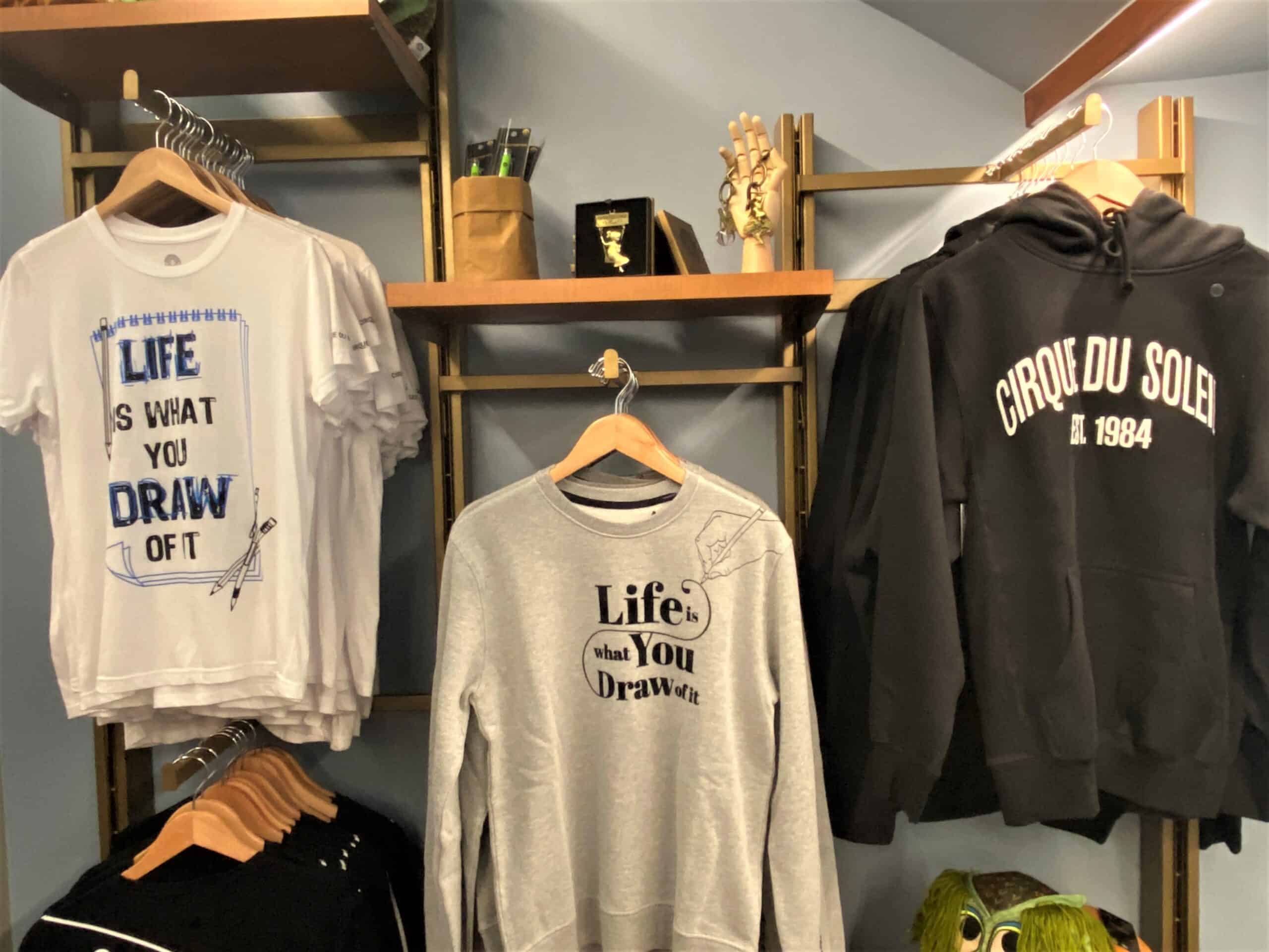 Cirque du Soleil Disney Springs Merchandise includes apparel with the slogan "Life is what you draw of it" printed on it, as well as merchandise that resemble animation tools like pencils and paper. 