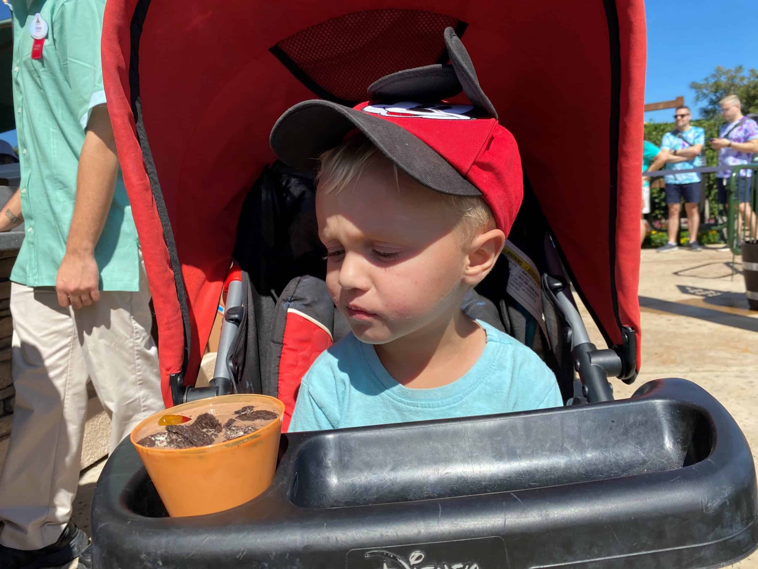 A four year old boy looks suspiciously at Cookie Butter Worms and Dirt drink - Epcot Flower and Garden 2022