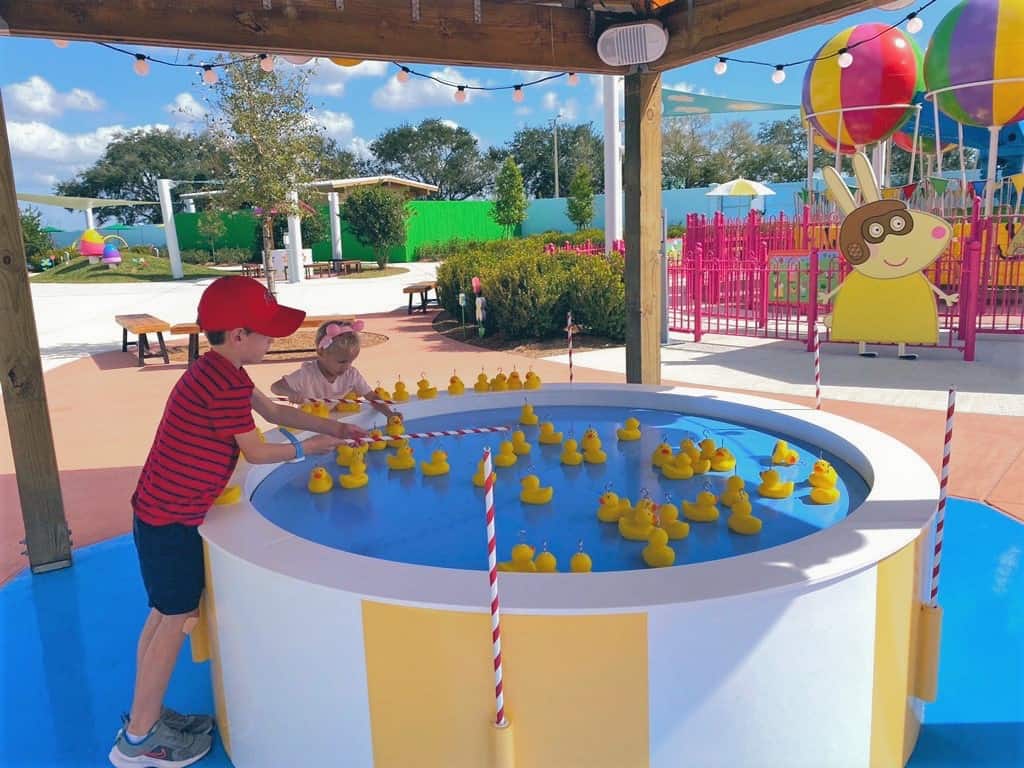 Two young boys play a rubber duck game at Peppa Pig Theme Park Florida