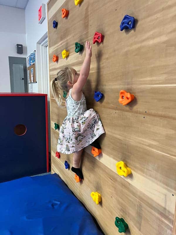 Toddler climbing rock wall