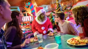 The Grinch dining with visitors