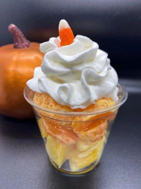 Healthy Candy Corn parfait with oranges, pineapple and whipped cream