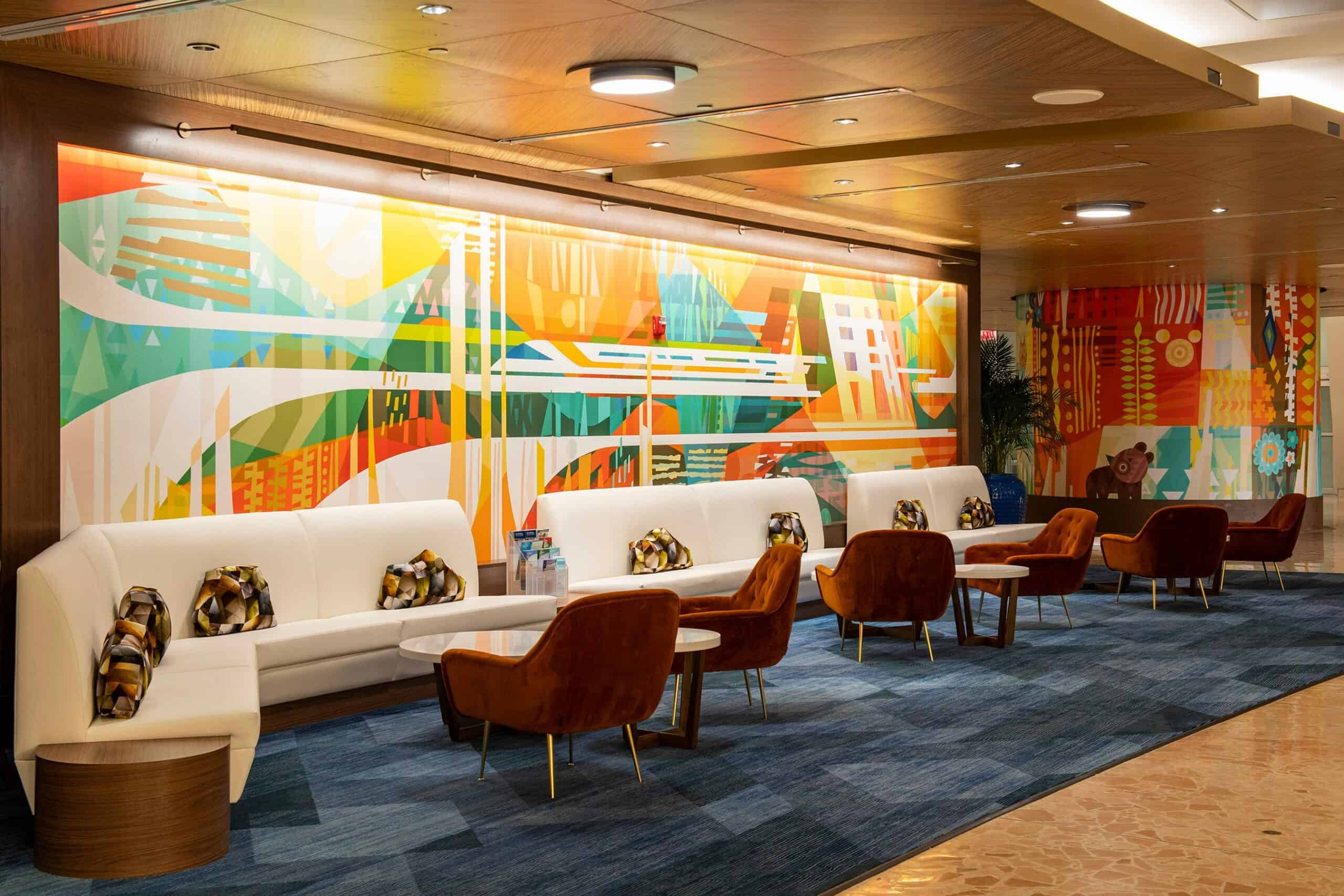 The recently updated lobby of Disney’s Contemporary Resort at Walt Disney World Resort in Lake Buena Vista, Fla., now features a collection of modern art pieces with bold, earthy tones. White couches are paired with deep orange chairs for a comfortable place to sit in the lobby. 