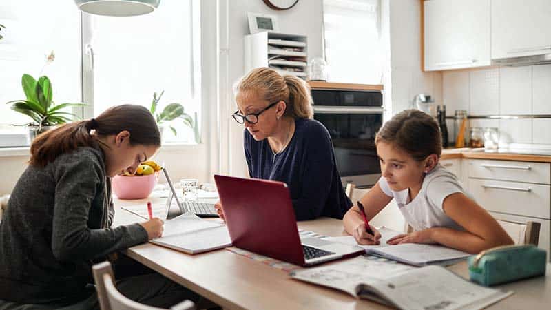 Mom and daughters study at home