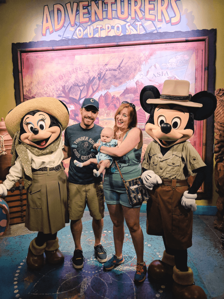 Mickey and Minnie Mouse wear safari outfits and meet a family of three at Disney's Animal Kingdom
