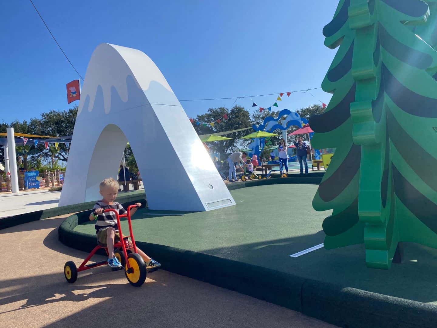 a 4 year old boy enjoys Peppa’s Pedal Bike Tour at Peppa Pig Theme Park 