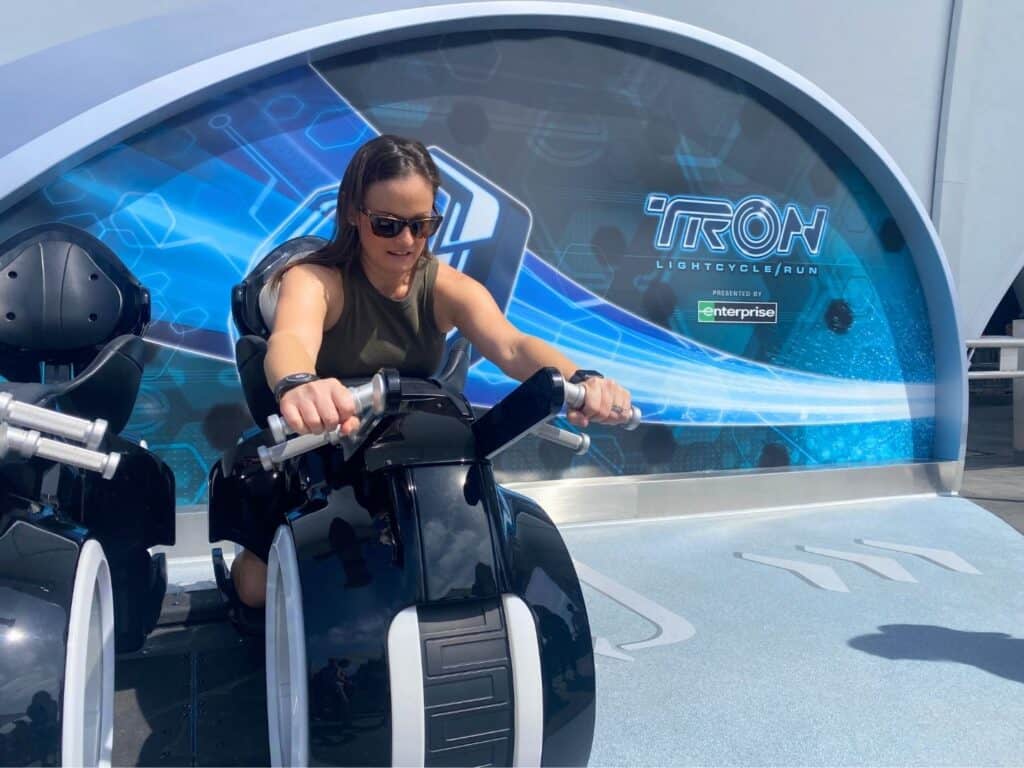 Brie Gorecki aboard TRON Lightcycle Run Test Lightcycle outside the attraction 