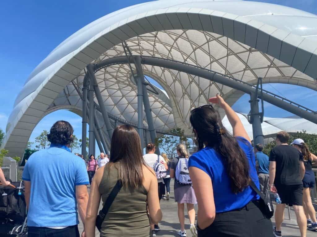 Walt Disney World representatives point out details of TRON Lightcycle Run canopy and track