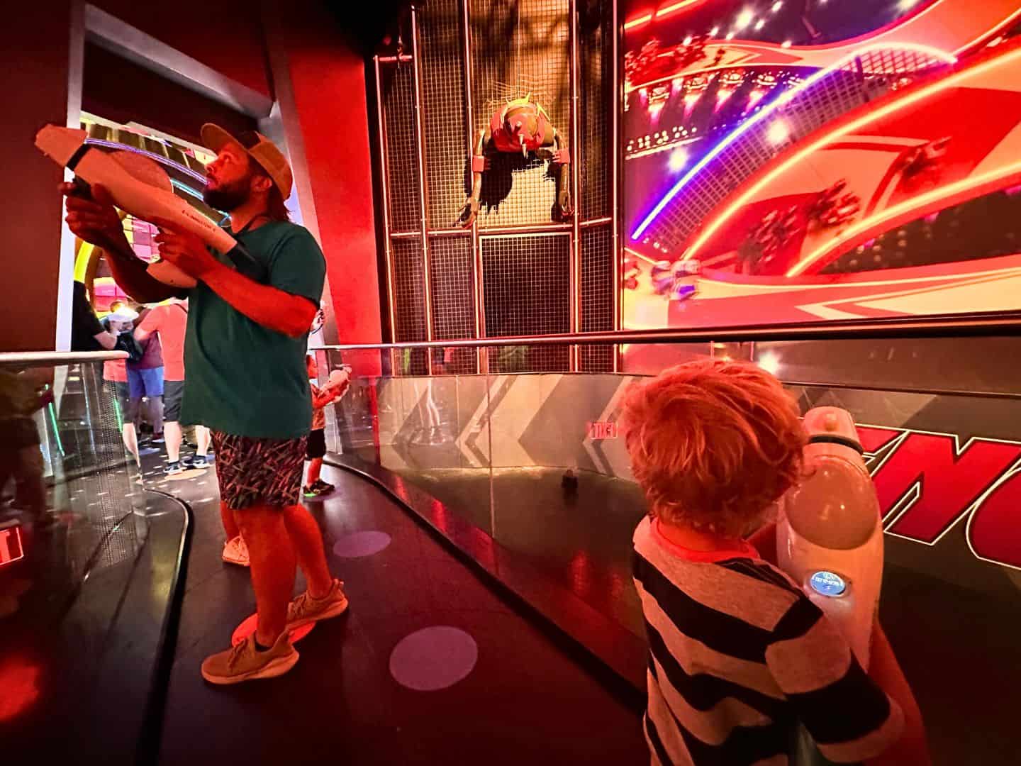 kids and adults use blasters to play Inside the Villain-Con Minion Blast Universal Orlando Ride
