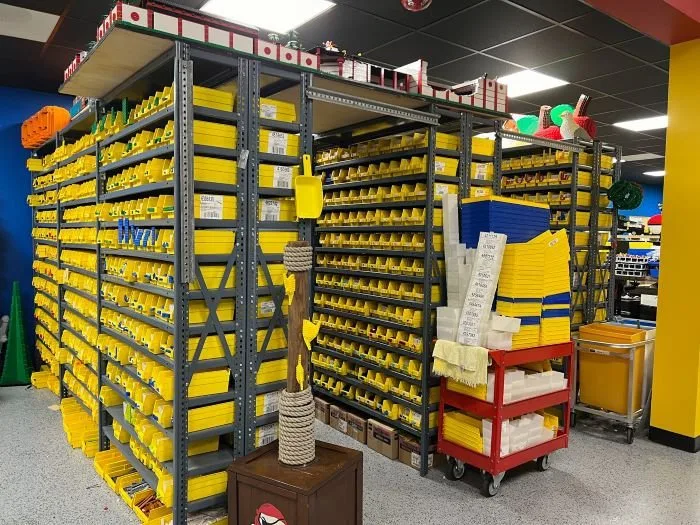 Legoland Florida Master Builder Workshop tour organizational shelves with millions of bins