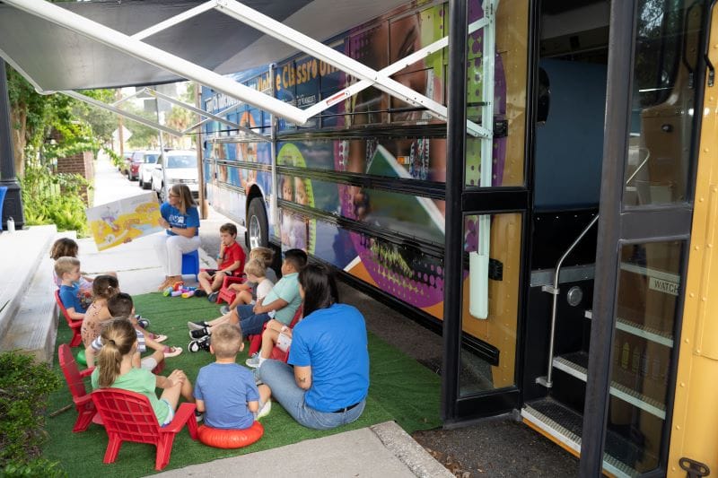the exterior of Paige the LIteracy bus includes an extendable awning for outside learning space
