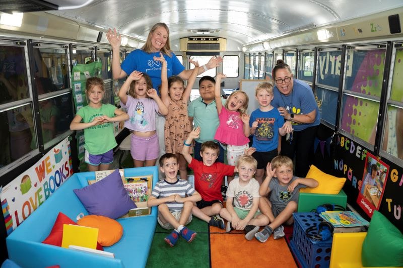 Silly picture of students and teachers inside Paige the Literacy Bus