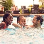 family splashing in pool knows the 5 layers of water safety