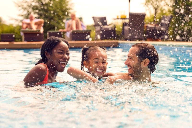 family splashing in pool knows the 5 layers of water safety