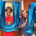 the authors kids hold "UF" balloons in reference to the college application process