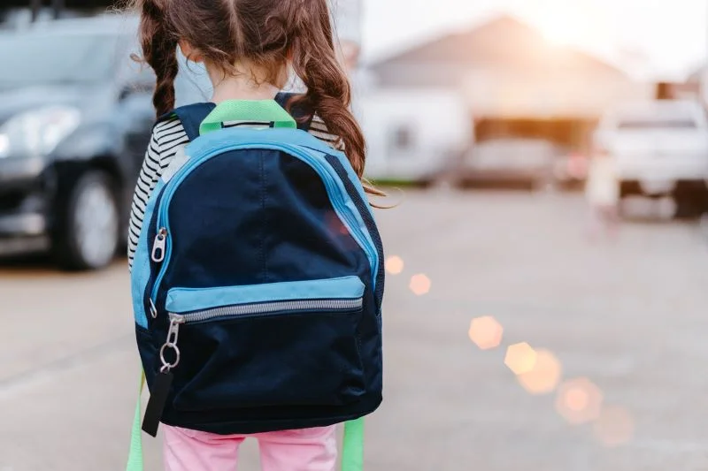 girl wearing backpack shows the importance of Backpack Safety Tips