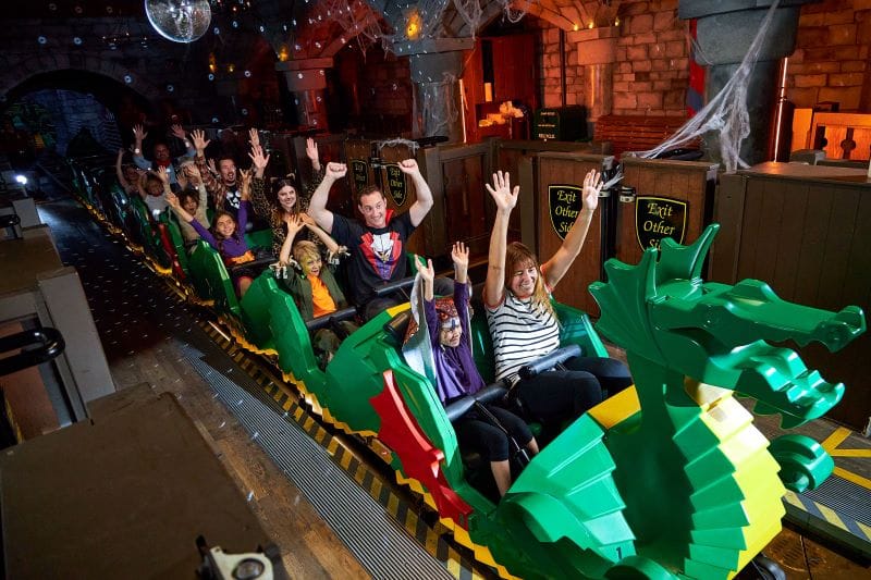 Disco Dragon roller coaster riders at Legoland Florida Brick or Treat