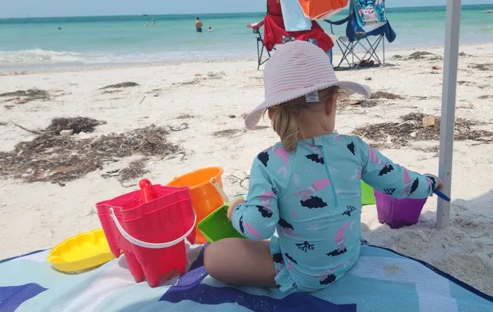 toddler playing in the sand at Pass a Grille Beach