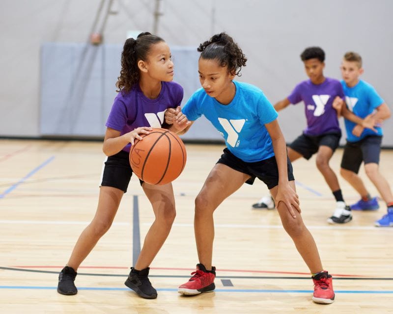 YMCA youth sports girls playing basketball