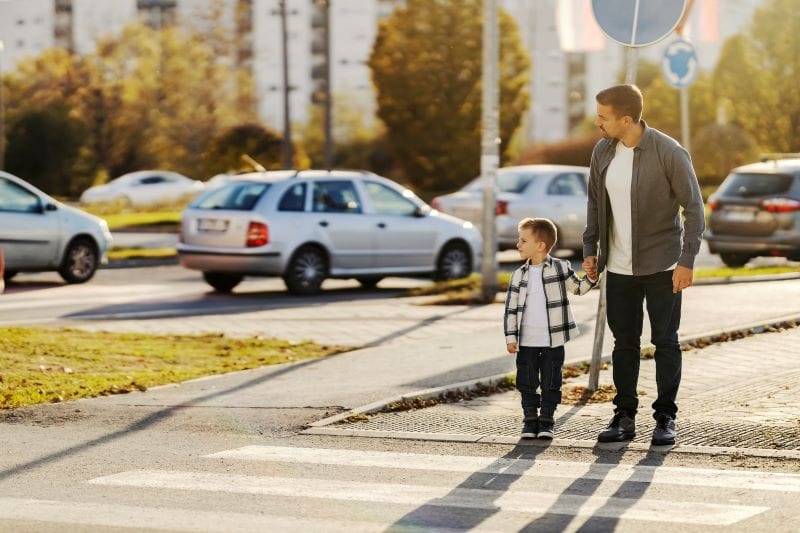 Sidewalk Safety child walking to school with Dad