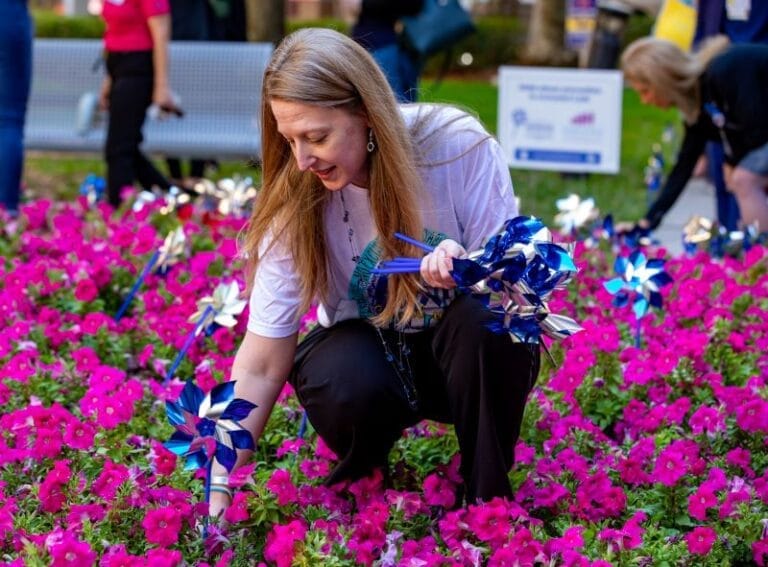 pediatric trauma care at TGH Muma Children's Hospital woman placing pinwheels for child abuse