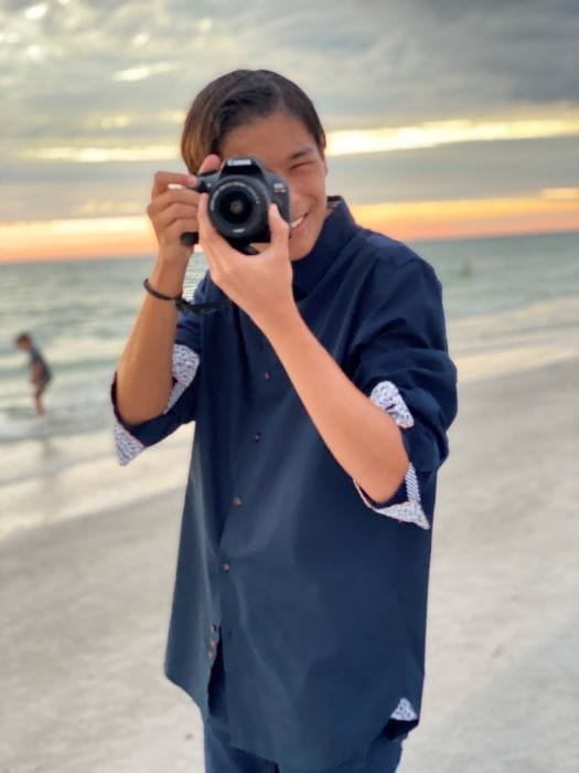 Jacob Ari Kamis taking a photo on the beach
