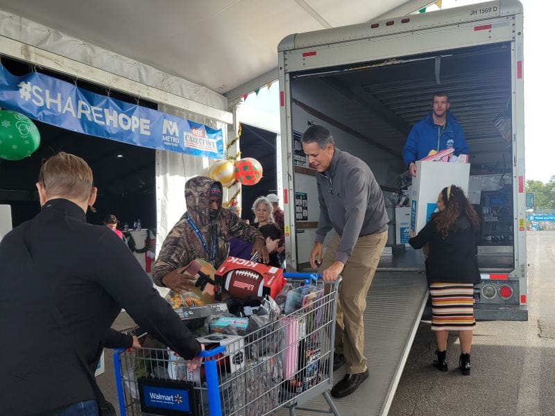 Volutneers unloading donations from truck for the Metropolitan Ministries Holiday Tent