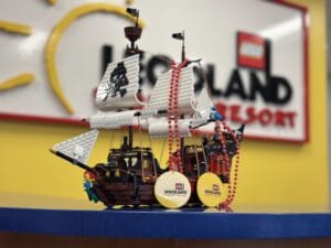 a lego pirate ship on a table in front of a legoland sign