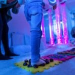 Therapist helping a young child Texture walk, sensory exploration, motor skills - getty images