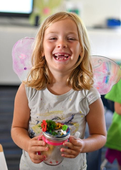 camper smiles at her Screen-Free Summer Camps