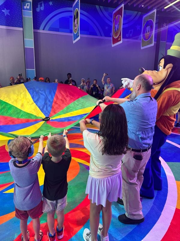 kids playing parachut with goofy character during GoofyCore Cool Kid Summer at EPCOT - image by Dani Meyering (8)