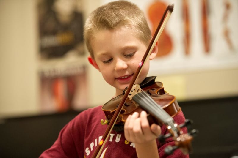 boy playing the violin at Marcia P. Hoffman school of the arts