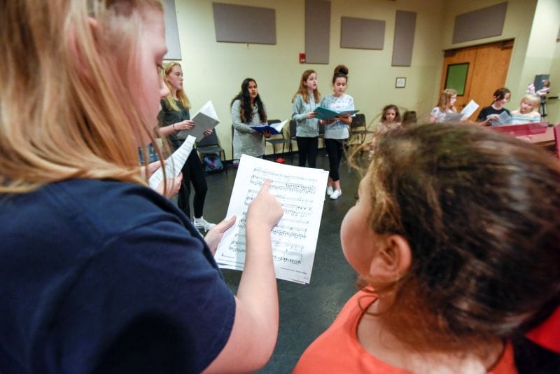 student learning from a teacher at an arts education class at Marcia P. Hoffman School of the arts