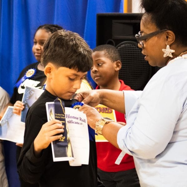 Student receiving recognition from teacher