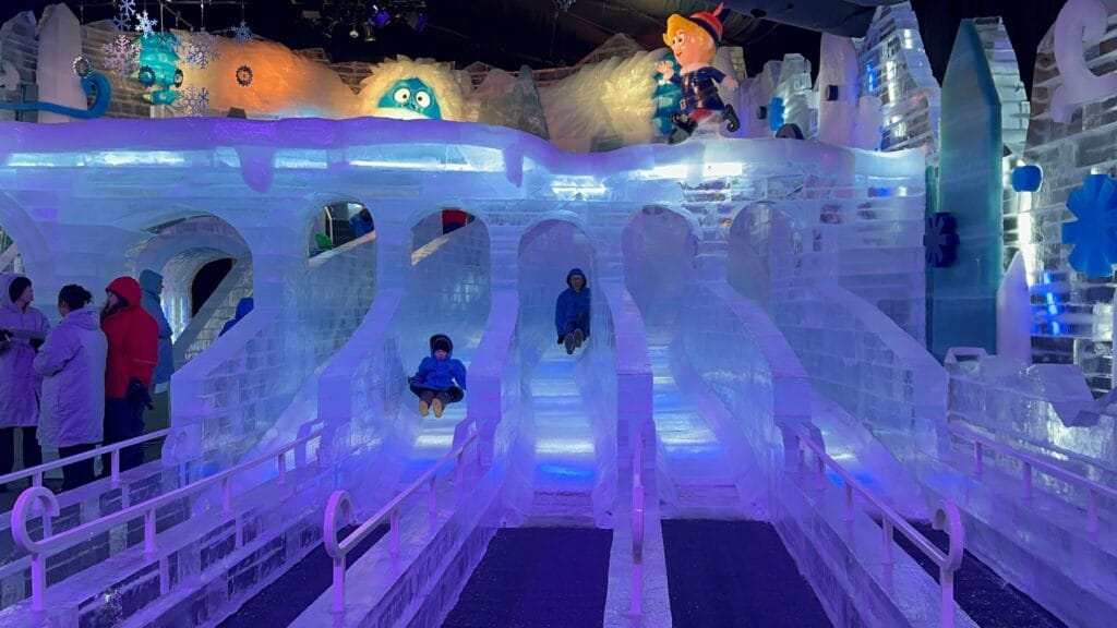 Father and son on ice slides at ICE! Gaylord Palms - image by Dani Meyering