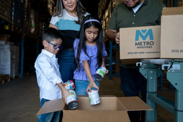 Metropolitan Ministries family donating food