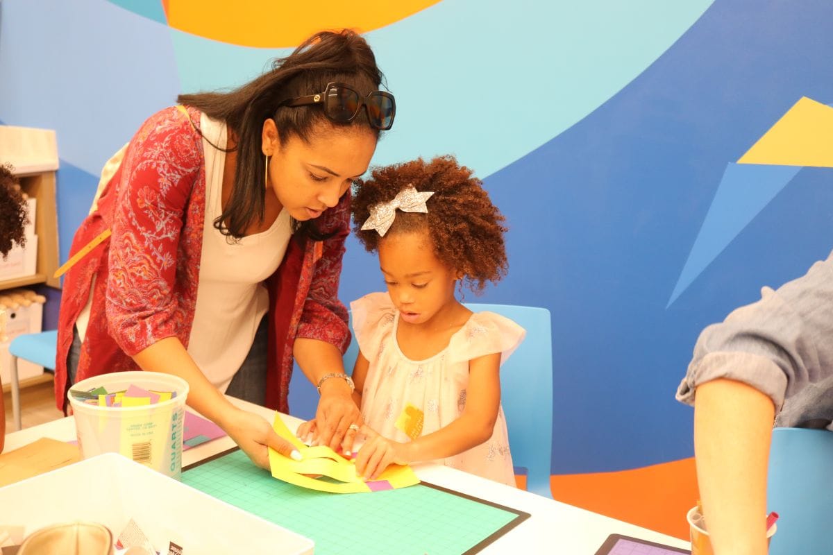 a parent helps her child with an art project at Ruth Eckerd Hall's Winter Break drop-in class