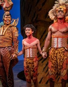 Jacob Pham on stage of Broadway's the Lion King at the end of the play.