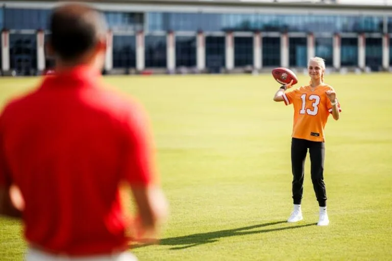 Tara Gramatica thowing a football to father Martin Gramatica