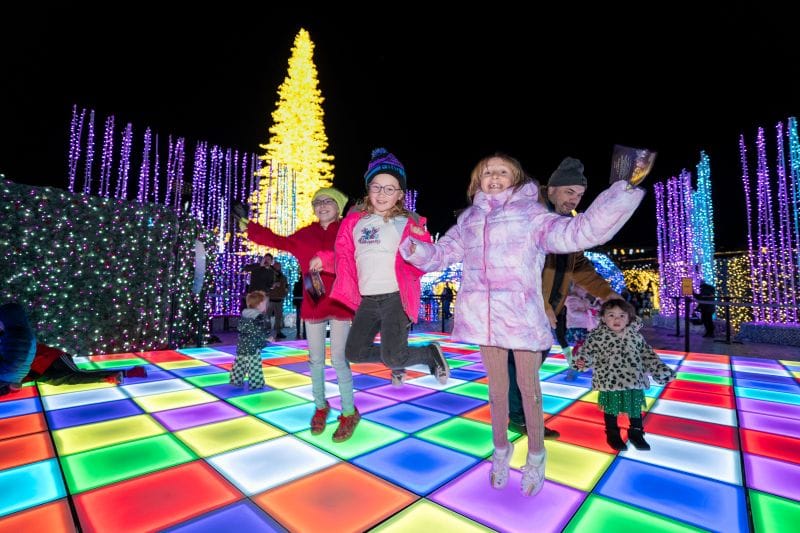 kids playing on the light-up dance floor at Enchant Christmas in St. Petersburg this Christmas