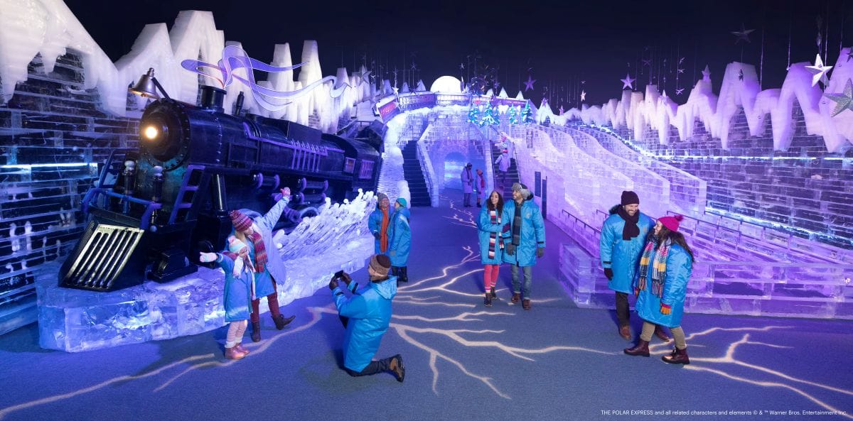 Guests wearing blue parkas inside ice! at Gaylord Palms with the Polar Express train and ice slides