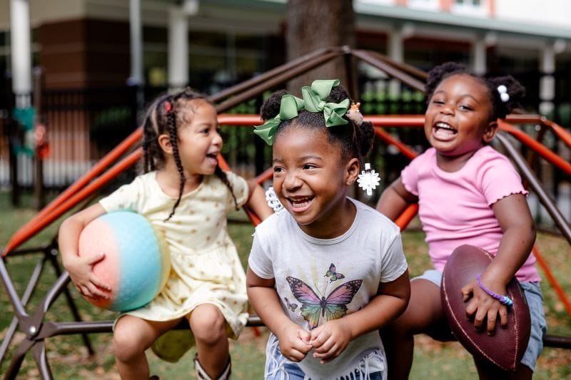 CREATE students laughing on playground